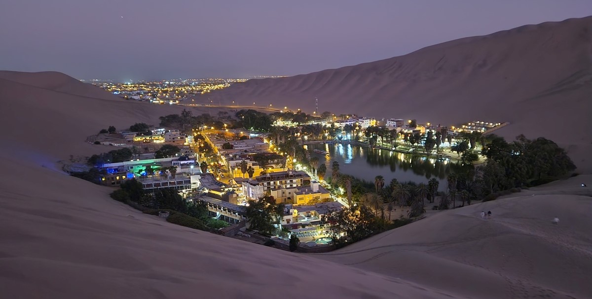 Huacachina oasis during twilight; even more beautiful! In the background the city of Ica Huacachina oasis during twilight; even more beautiful! In the background the city of Ica